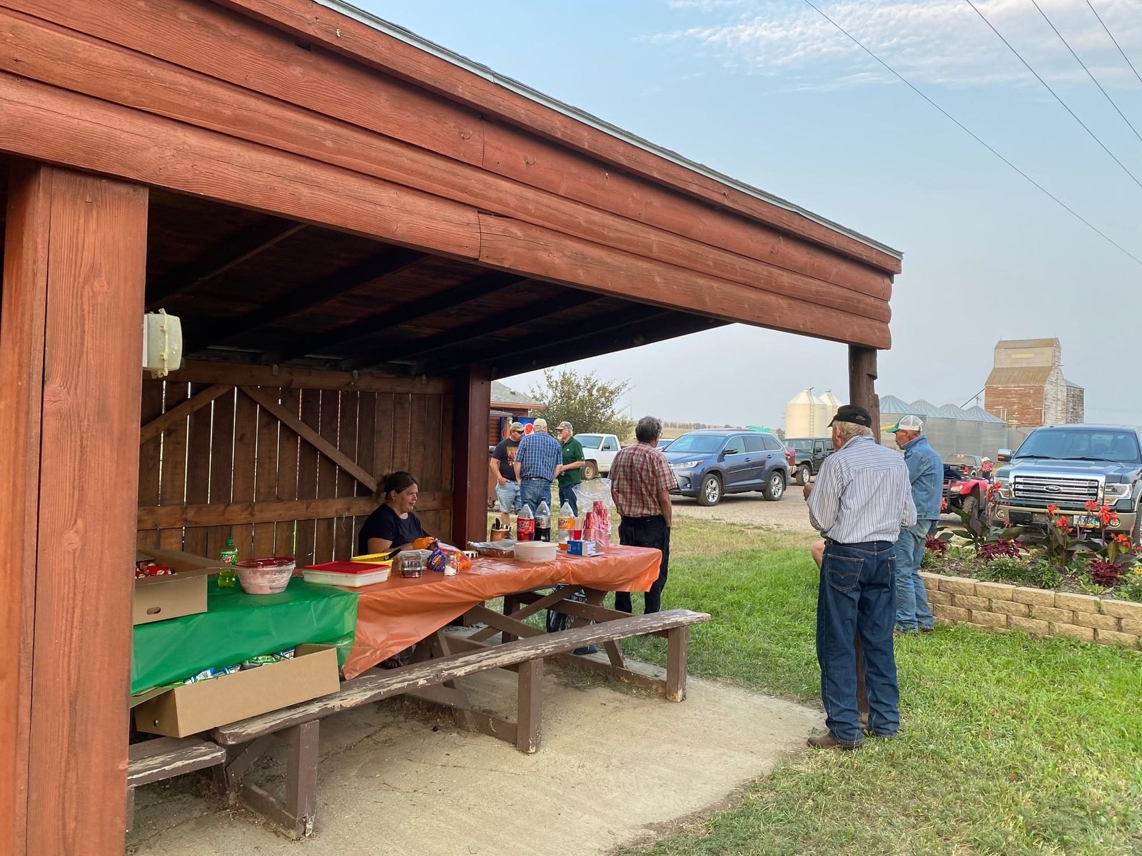 The covered picnic shelter at the Dodge city park set with food for a community gathering